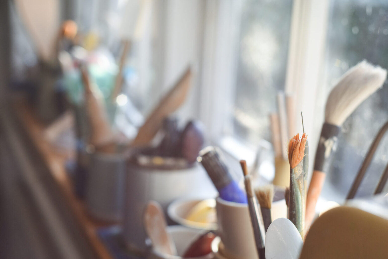 Paint brushes pens pencils and other art tools and equipment in