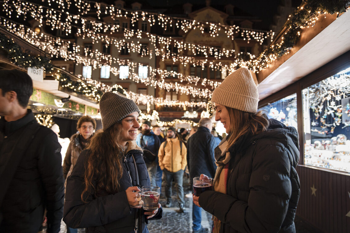 Zwei Frauen unterhalten sich bei einer Tasse Glühwein