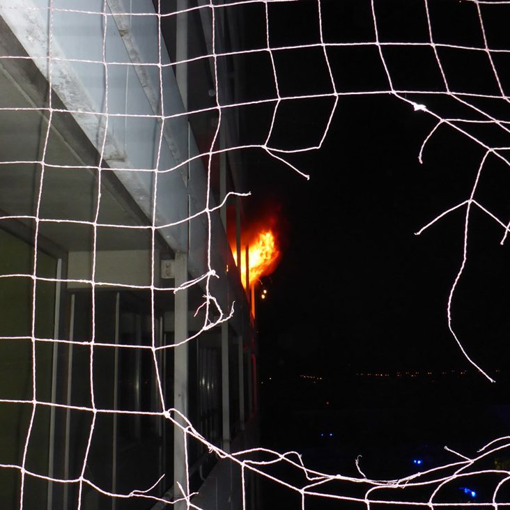 Flames are leaking out of the building.