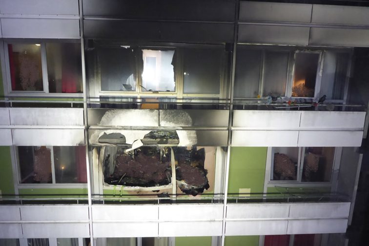 Fire damage to the front of the high-rise building.